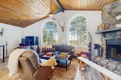 a living room with a couch and a fireplace at Lakeview Lookout in Skyforest