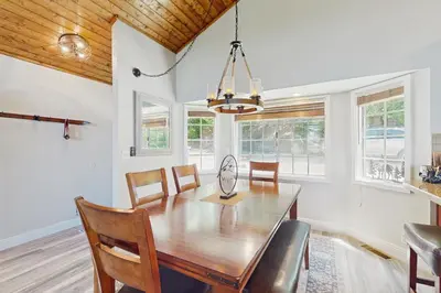 a dining room with a wooden table and chairs at Lakeview Lookout in Skyforest