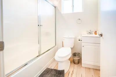 a white bathroom with a toilet and a shower at Modern 2 Bedroom 3 Level Loft by Hollywood Close to Downtown LA Free Gated Parking Full Kitchen in Los Angeles