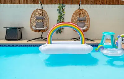a kindergarten pool with a pool float in the water with a rainbow at LA Luxury Home with Private Pool & Gym 4 beds Prime Location in Los Angeles