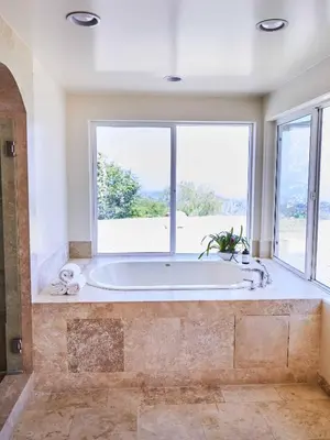 a large bathroom with a tub with a large window at Oja Mountain Ridge in Ojai