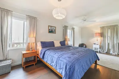 a bedroom with a bed with a blue comforter at Silver Lake Cozy Getaway in Los Angeles