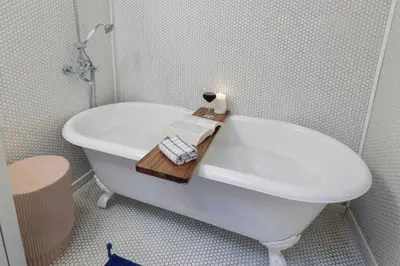 a bathroom with a bath tub with a book on it at Silver Lake Cozy Getaway in Los Angeles