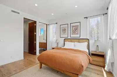 a bedroom with a bed with a orange blanket at Vast Mar Vista Residence in Los Angeles