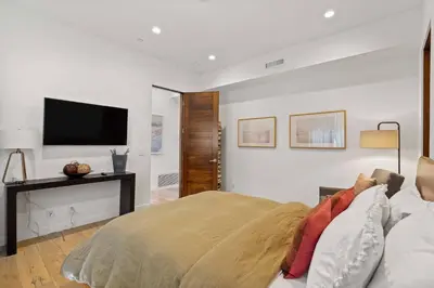 a bedroom with a bed and a flat screen tv at Vast Mar Vista Residence in Los Angeles