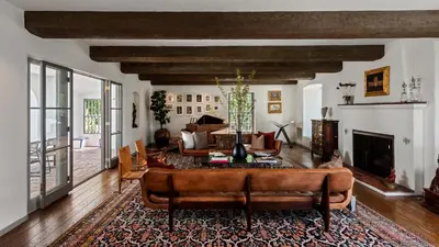 a living room with a couch and a fireplace at Howard Hughes Estate in Los Angeles
