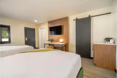 a hotel room with two beds and a television at LYFE INN & SUITES by AGA- North Hollywood Near Universal Studios in North Hollywood