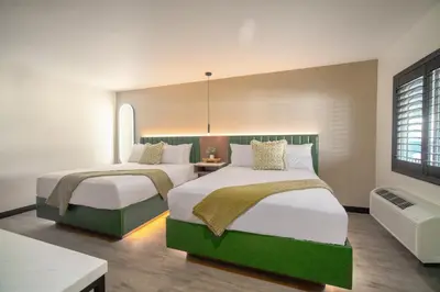 a hotel room with two beds and a television at LYFE INN & SUITES by AGA- North Hollywood Near Universal Studios in North Hollywood