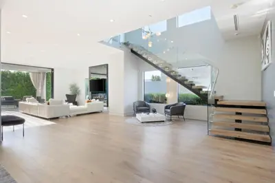 a living room with white furniture and a staircase at The Artezen Villa by Stay Awhile Villas in Los Angeles