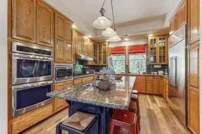 a kitchen with wooden cabinets and a granite counter top at Summit Sanctuary in Lake Arrowhead