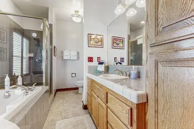 a bathroom with a sink and a tub and a toilet at Summit Sanctuary in Lake Arrowhead