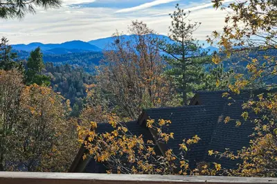 a roof of a house with mountains in the background at Summit Sanctuary in Lake Arrowhead
