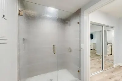 a shower with a glass door in a bathroom at Seaspray at Anacapa View in Port Hueneme