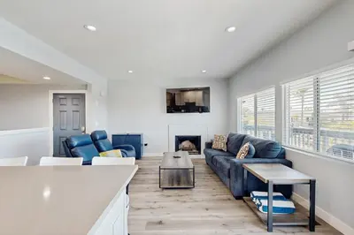 a living room with a couch and a fireplace at Seaspray at Anacapa View in Port Hueneme