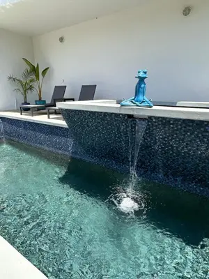 a fountain in the middle of a swimming pool at Hollywood Hills Luxury Retreat in Los Angeles