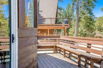 a deck with a bench and a balcony at Castle Rock Cabin #1 ~ Comfortable cabin with modern amenities and deck - near hiking and lake in Big Bear Lake