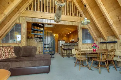a living room with a couch and a table at Castle Rock Cabin #2 ~ Cozy cabin close to Fisher Cove & Boulder Bay - short drive to skiing in Big Bear Lake