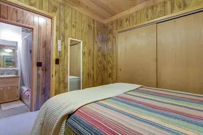 a bedroom with a bed and a bathroom at Castle Rock Cabin #2 ~ Cozy cabin close to Fisher Cove & Boulder Bay - short drive to skiing in Big Bear Lake