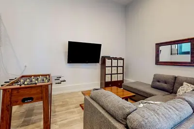 a living room with a couch and a tv at Hillside Hideaway ~ Dog-friendly home with wraparound deck, grill, game room, & bar - walk to dining in Big Bear Lake
