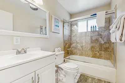 a bathroom with a sink and a toilet and a shower at Meadow-Front Metcalf Bay Cabin Hot Tub, Air Hockey, Firepit & Lake Views in Big Bear Lake