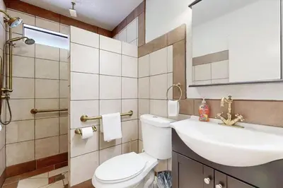 a bathroom with a white toilet and a sink at Lazy Bear Cabin ~ Dog-friendly home with private hot tub, ping-pong, basketball & firepit in Big Bear Lake