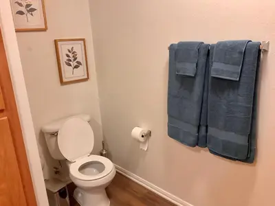 a bathroom with a toilet and two blue towels at Luxe Stay Marina Del Rey in Los Angeles