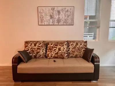 a couch sitting in a living room under a painting at Luxe Stay Marina Del Rey in Los Angeles