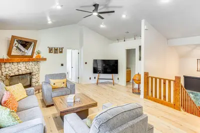 a living room with a couch and a fireplace at Forest Views and Fire Pit! Cozy Cabin in Crestline in Crestline