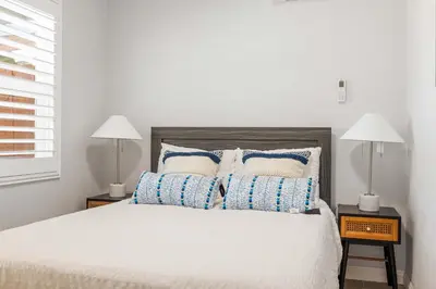 a bedroom with a bed with blue and white pillows at #Marbella lane - Serene Haven Retreat 3BR in Ontario