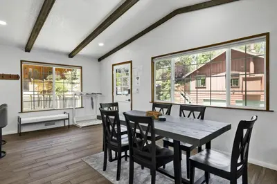 a dining room with a table and chairs at The Fox Den Big Bear ~ Modern Mountain View Retreat w/ Hot Tub in Big Bear City