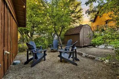 three blue chairs and a table in a yard at Orchard Family Cabin Near Historic Big Bear Village Walk to Marina in Big Bear Lake