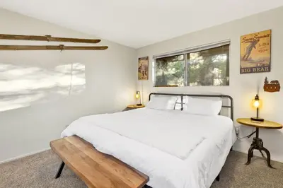 a white bedroom with a bed and two windows at Orchard Family Cabin Near Historic Big Bear Village Walk to Marina in Big Bear Lake