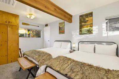 two beds in a bedroom with white walls at Orchard Family Cabin Near Historic Big Bear Village Walk to Marina in Big Bear Lake