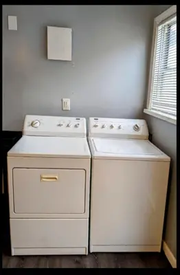 two white appliances in a kitchen with a window at Spacious 3 bedroom home by Melrose and 10 minutes to Hollywood Walk of Fame in Los Angeles