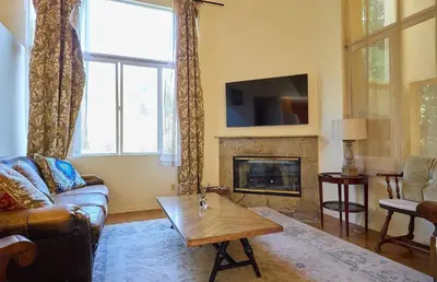 a living room with a couch and a fireplace at Malibu Nature Escape - 2BR Hideaway Nestled in the Woods, Minutes from the Beach in Malibu
