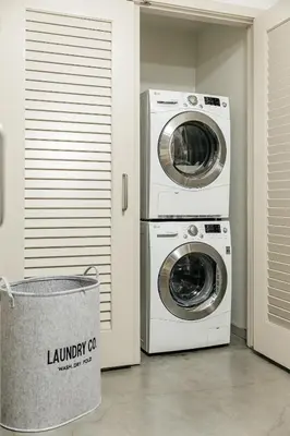 two washing machines and a laundry basket in a room at Palm & Vine MODERN COZY LOFT in HOLLYWOOD, FREE Parking in Los Angeles