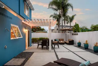 a patio with a pergola and a table and chairs at Sea La Vie by Paradise Retreats in Ventura
