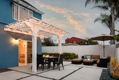 a patio with a pergola with a table and chairs at Sea La Vie by Paradise Retreats in Ventura