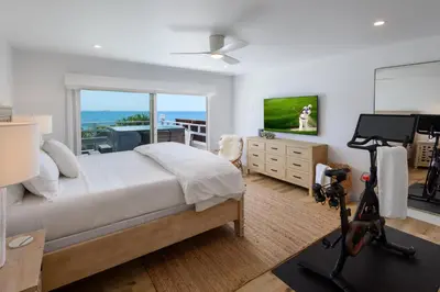a bedroom with a bed and a view of the ocean at The Cove at Rincon by Paradise Retreats in Carpinteria