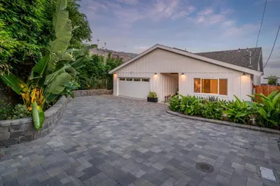a house with a driveway and a garage at The Cove at Rincon by Paradise Retreats in Carpinteria