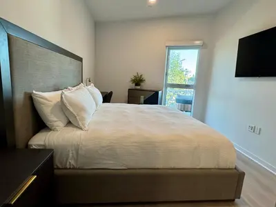 a bedroom with a large bed and a window at Silver Lake 1 Bedroom Condo Suite with Balcony and Parking in Los Angeles