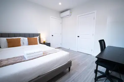 a bedroom with a bed and a desk and a table at Modern 2BR2BA Home Near USC Walk to Campus in Los Angeles