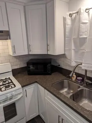 a kitchen with white cabinets and a sink and a microwave at STADIUM LUXURY - CONDO for 4 STEPS AWAY FROM SOFI in Inglewood
