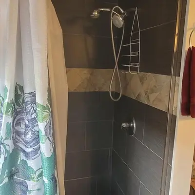 a shower with a shower head in a bathroom at BH Adj, studio spacious BH in Los Angeles