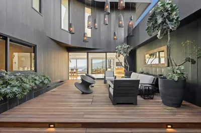 a living room with a wooden floor and furniture at Surfside Malibu by Stay Awhile Villas in Malibu
