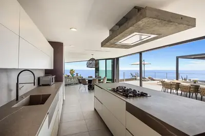an open kitchen with a view of the ocean at Malibu Oceana Bleu by Stay Awhile Villas in Malibu Beach