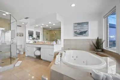 a large bathroom with a large tub and a sink at Malibu Oceana Bleu by Stay Awhile Villas in Malibu Beach