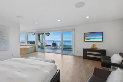 a bedroom with a bed and a view of the ocean at Malibu Oceana Bleu by Stay Awhile Villas in Malibu Beach