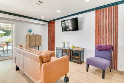 a living room with a couch and a chair at Relax Fireside Hacienda Heights Gem with Patio! in Hacienda Heights