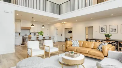 a living room with a couch and a table at Luxury Retreat 5mins to the Lake Game Room Fire Pit Howlite by AvantStay in Lake Arrowhead
